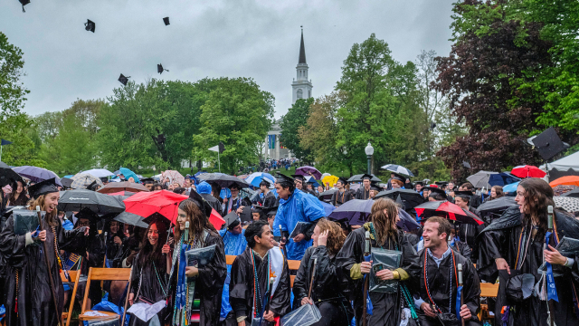 Middlebury students toss their caps in the air following Commencement.