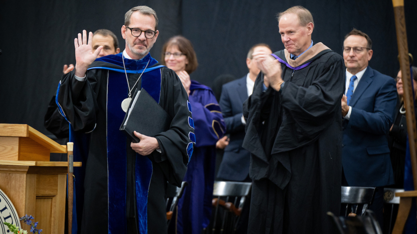Middlebury President Ian B. Baucom stands at lectern.