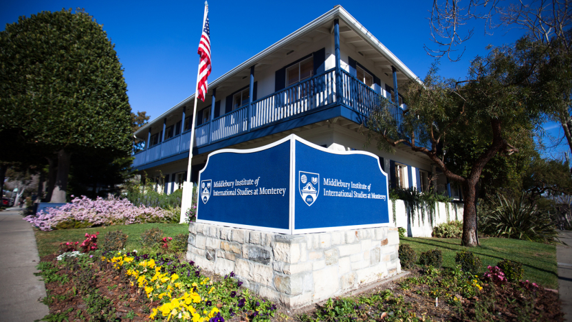 A sign for the Middlebury Institute of International Studies in front of a campus building.