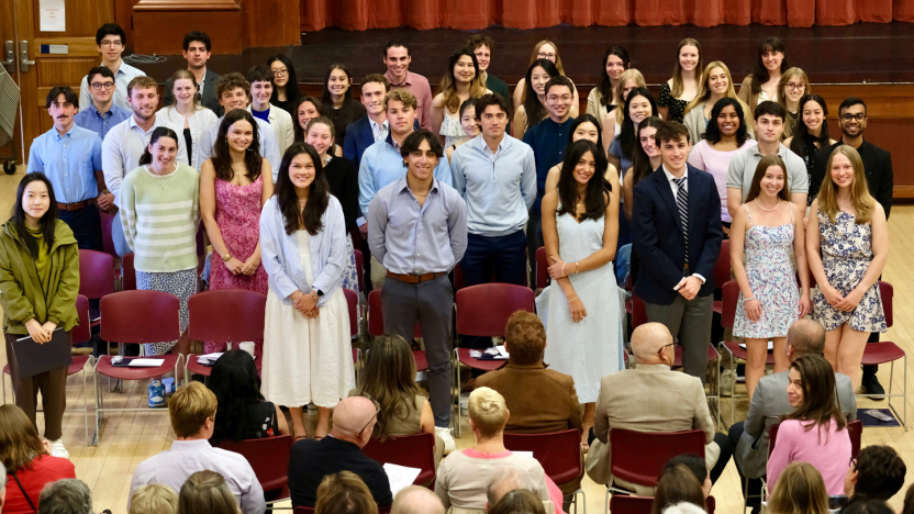 A group of students poses for a photo during a ceremony.