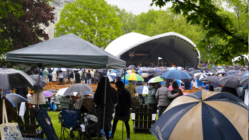Photo of rainy commencement grounds with umbrellas.