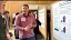 A student presents research findings during a poster session.