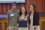 Three people pose for a photo during an awards ceremony.