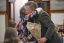 Two people in a celebratory hug during an awards ceremony.