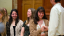 A student learns the Phi Beta Kappa handshake.