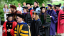 Faculty in academic regalia in a procession outdoors.
