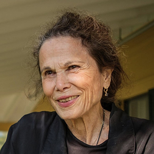 Julia Alvarez smiling on Bread Loaf Inn Porch