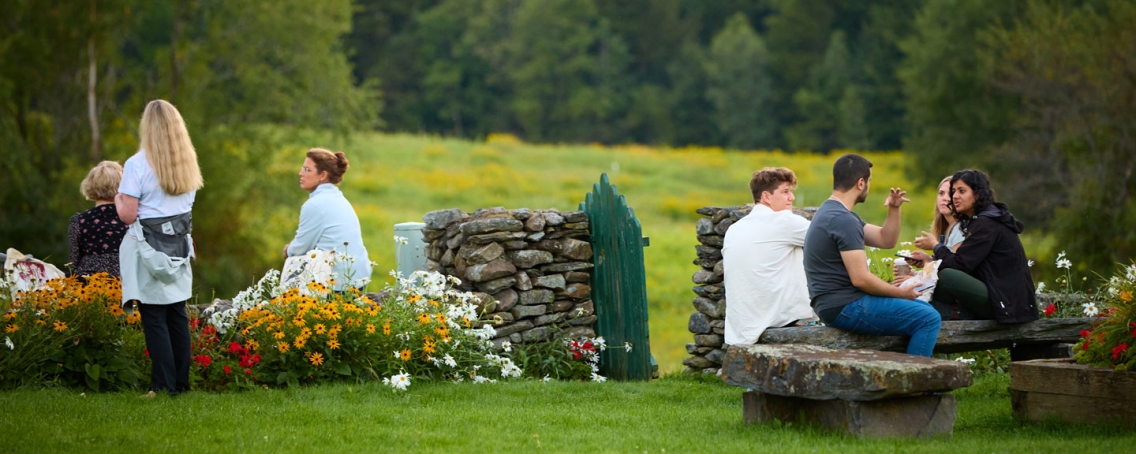 Conference students gather in the fields of the Bread Loaf campus.