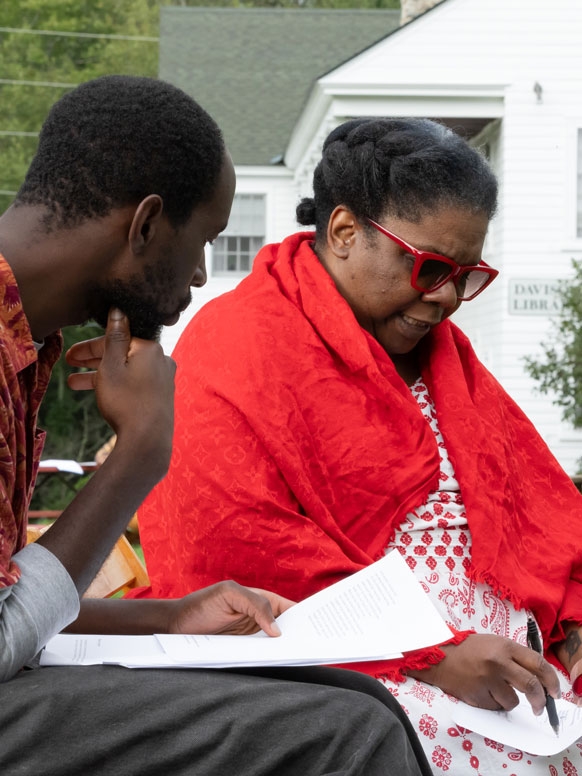Two attendees discussing a piece of writing.